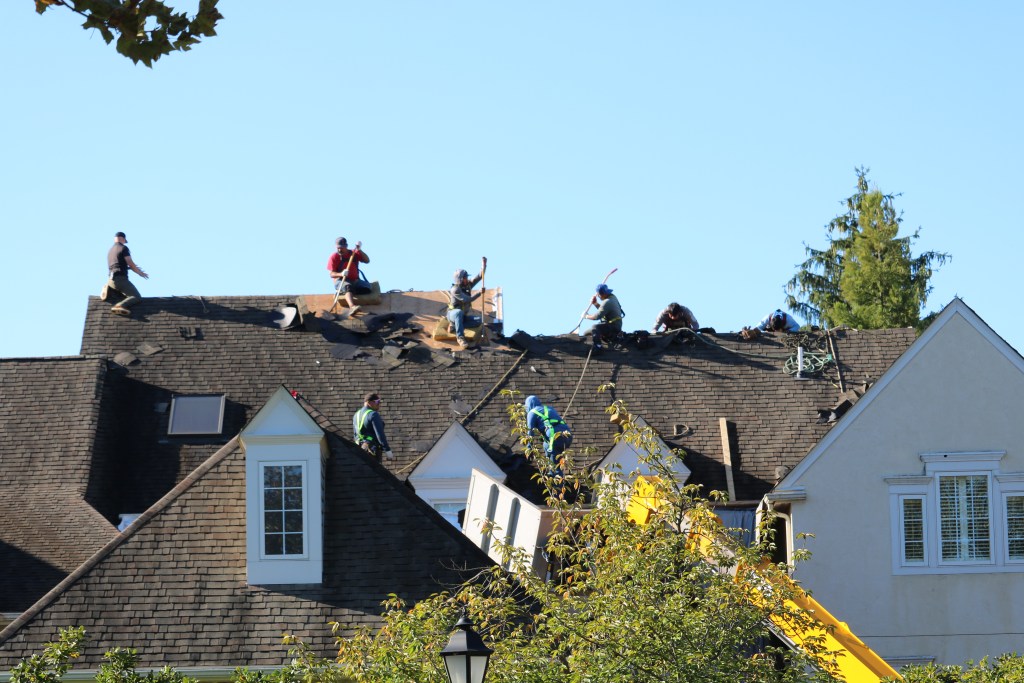 Lemus Construction team installing new shingles on Applebrook roofs, Malvern PA
