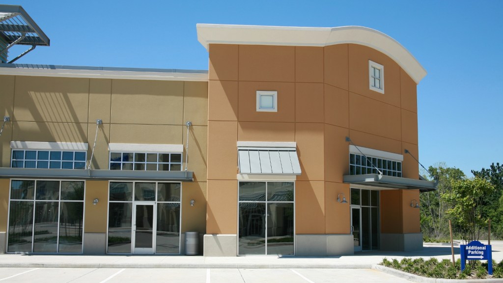 Commercial building façade upgrade with fiber cement panels and metal cladding installed by Lemus Construction