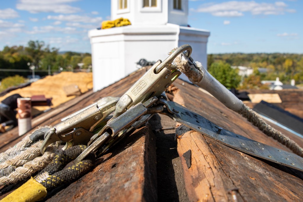 Safety supervisor checking equipment on Phoenixville roof