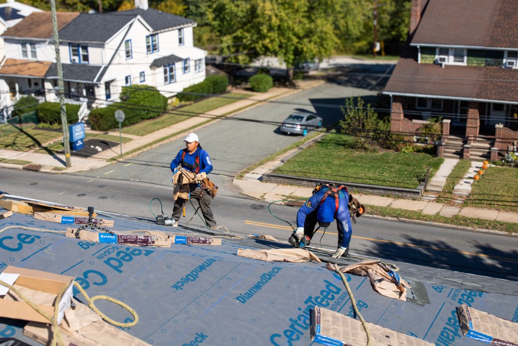 Crew installing new shingles on Phoenixville Federal Bank roof