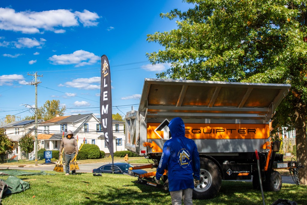 Cleanup crew managing debris after roof replacement