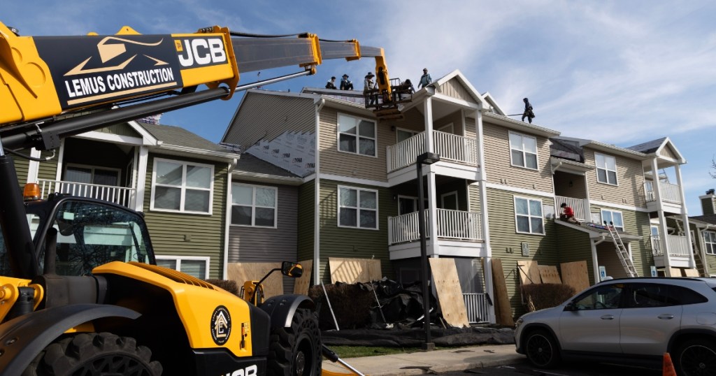 Lemus Construction crew installing roofing at Hunters Chase Apartments
