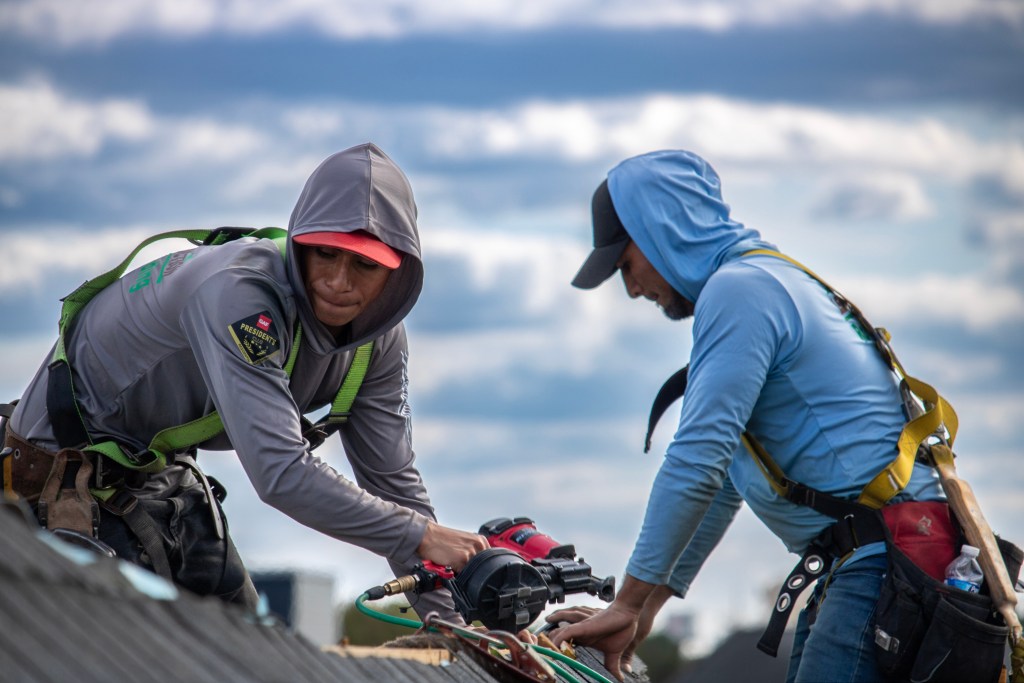 Team member installing roof vents at The Villas at Packer Park, Philadelphia