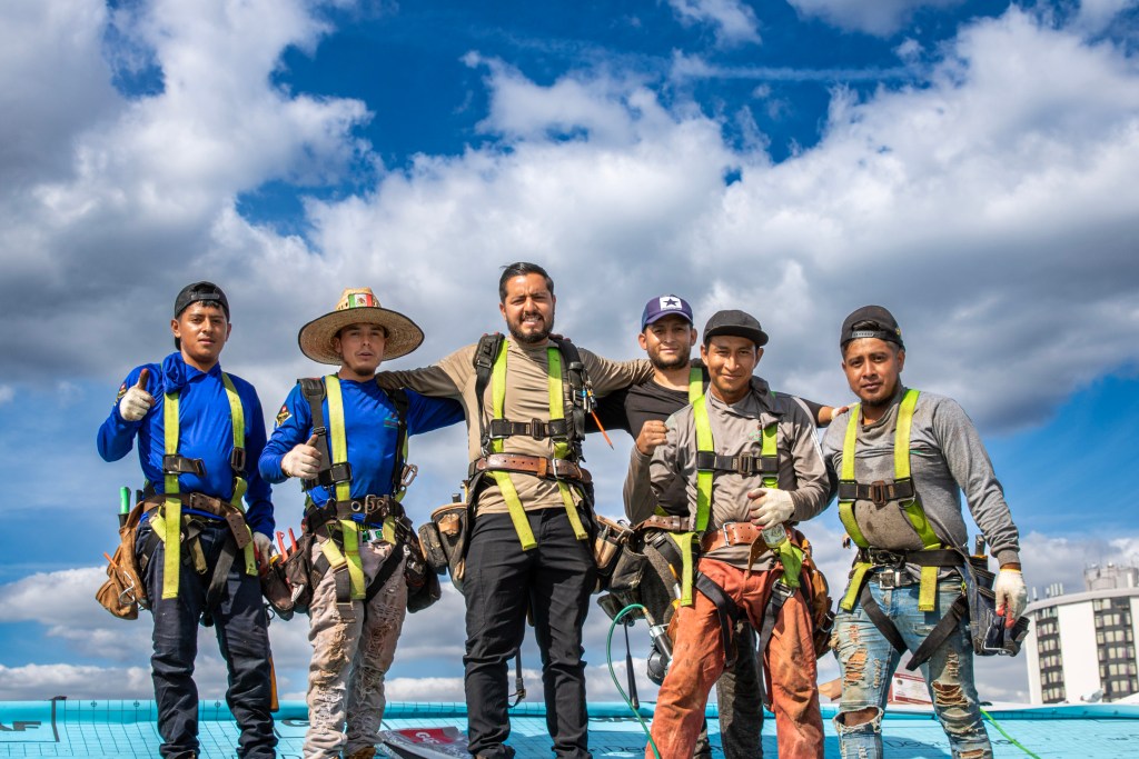 Lemus Construction team members on a rooftop at The Villas at Packer Park, Philadelphia, PA – Lemus Roofing & Gutters Packer Park Philly