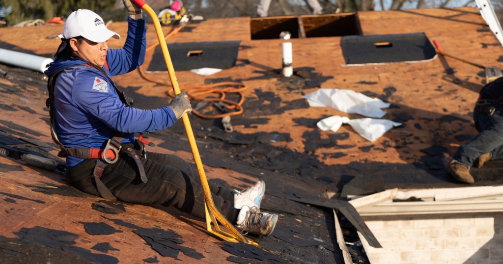 Forge roof replacement aerial view showing Lemus Construction crew removing old shingles
