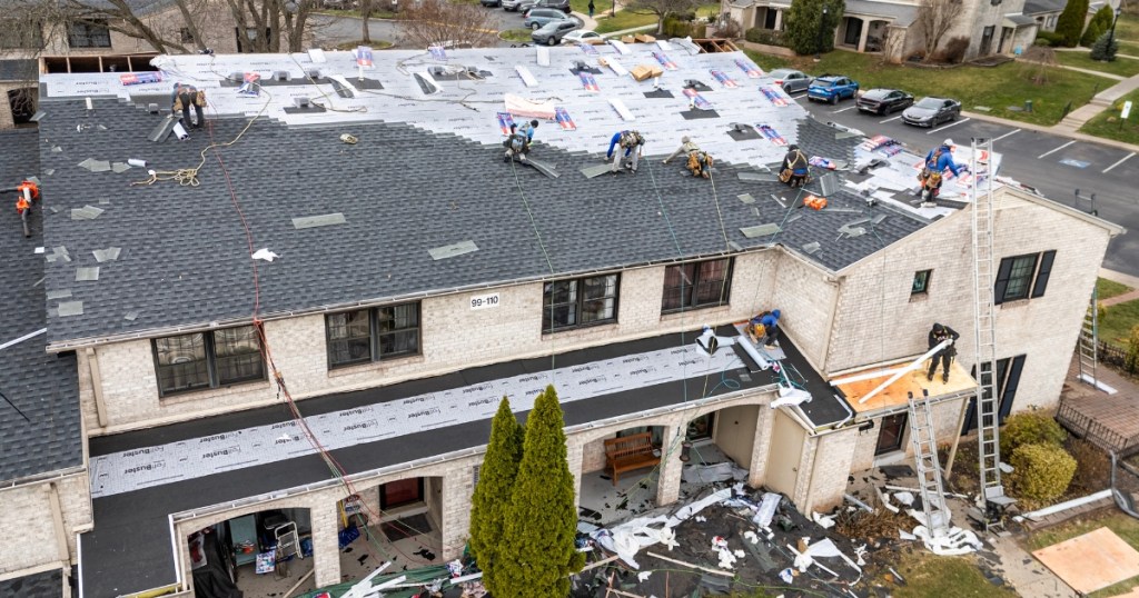 Providence Forge roof replacement aerial view showing crew installing final roof shingles