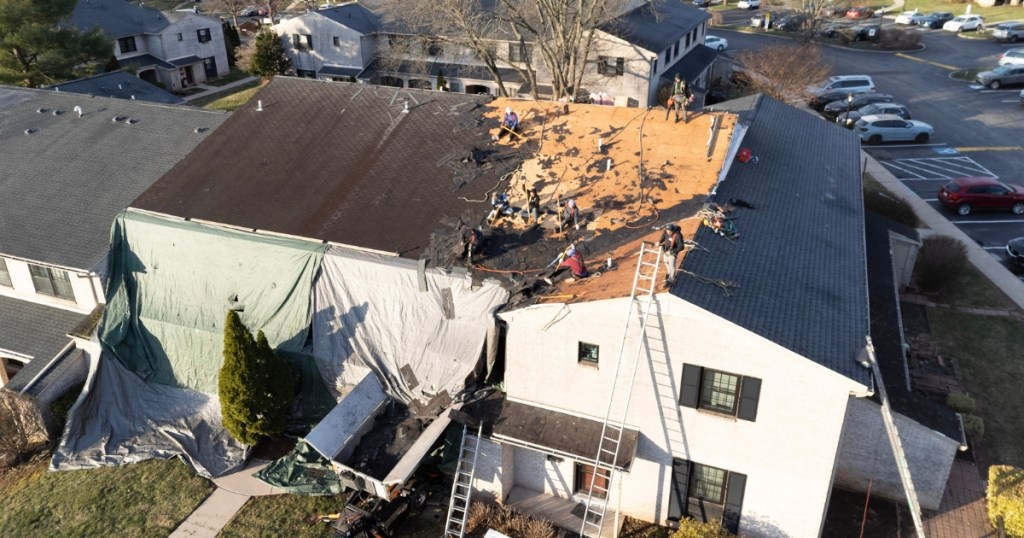 Providence Forge roof replacement aerial view showing crew removing old shingles